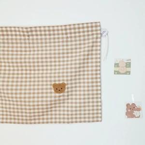 Detail of bear embroidery on brown plaid cotton linen car sunshade with suction cup