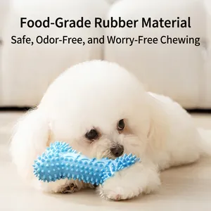 Blue rubber bone dog toy with massage nubs shown with a small white puppy