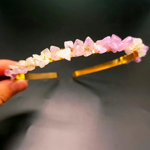 Detailed view of handmade gold metal headband featuring raw purple amethyst crystals