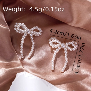 Detail of bow earrings with faux pearls showing 4.5cm height and 4.2cm width dimensions