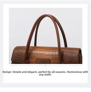 Detail of brown crocodile pattern handbag with dual handles and polished leather texture