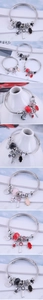 Detail of adjustable silver bangle with faceted crystal beads and symbolic charms