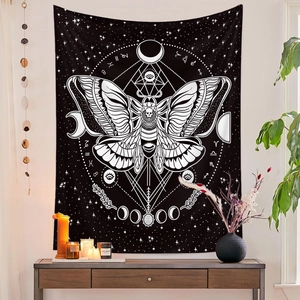 Detail of bohemian butterfly tapestry with moon phases and zodiac signs on a white wall