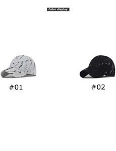 Detail view of tie-dye baseball caps showing marble print in white and black styles