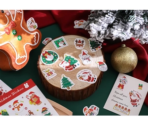 Close-up of colorful Christmas stickers featuring Santa and reindeer on wooden decor