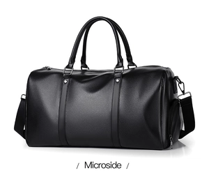 Close-up of black lychee grain leather texture and metallic hardware on fitness bag