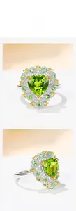 Detailed macro view of heart-shaped green peridot ring with micro-pave gemstone setting