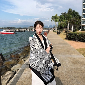 Close-up of ethnic style beach shawl with retro totem prints and tassel details