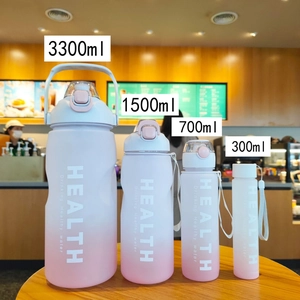 Set of four gradient pink and white matte sports water bottles in various sizes