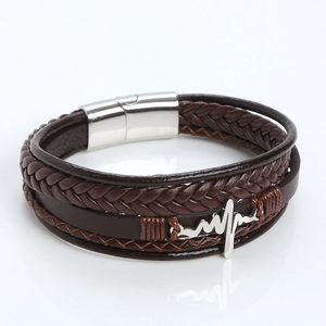 Macro detail of men's layered leather bracelet with ECG charm and magnetic clasp