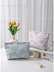 Two swan jacquard makeup bags in pink and blue colors on a bright aesthetic desk