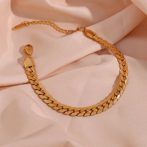 Close-up of 18K gold plated curb chain bracelet with lobster clasp on pink silk