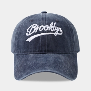 Vintage washed navy blue Brooklyn baseball cap with 3D white embroidery on a grey background