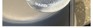 Detail of high borosilicate glass tumbler with minimalist typography and clear liquid