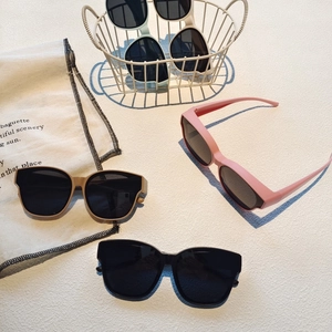 Detailed display of colorful silicone kids sunglasses in pink, black, and mint green