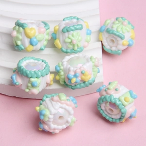 Detail of handcrafted resin beads with 3D floral and heart patterns for DIY jewelry