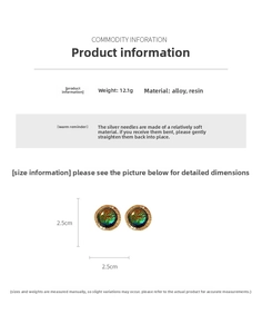 Detail view of round vintage earrings with blue resin and gold wavy alloy edges