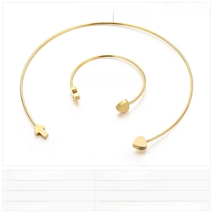 Macro detail of golden stainless steel heart and cross jewelry set with dimensions