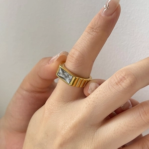 Vintage gold stainless steel ribbed ring featuring a rectangular white zircon on hand