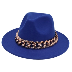 Detail of navy blue felt fedora featuring a chunky rose gold Cuban chain decoration