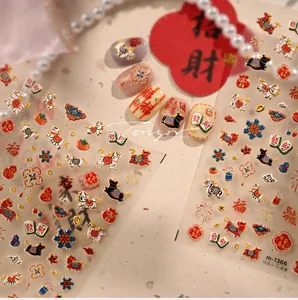 Detail of New Year nail stickers with lucky charms, mahjong motifs and gold outlines