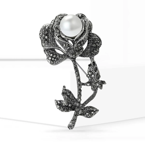 Vintage rose brooch in gunmetal silver with black crystals and a white pearl accent