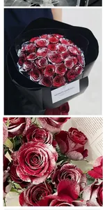 Detailed view of red roses with artificial frost effect in black bouquet packaging