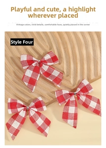 Close-up of three red and white plaid Christmas bows with silver wire centers