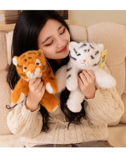 Close-up of soft plush tiger dolls in orange and white with realistic fur and details