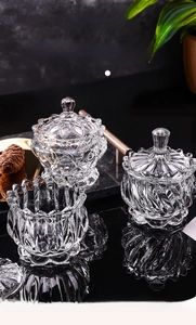 Detailed macro view of three glass candy jars with lotus and diamond relief patterns