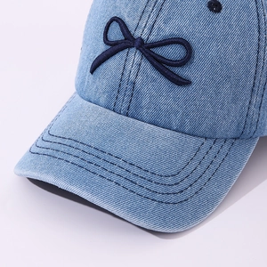 Classic light blue denim baseball cap for kids featuring a dark blue bow applique detail