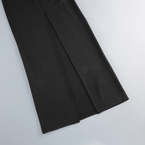 Detailed close-up of the elegant side slit hem on a black formal evening dress