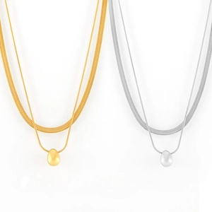 Double-layered gold and silver snake chain necklaces with polished teardrop pendants