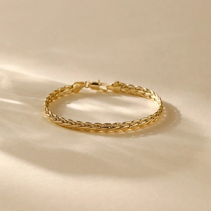 Detail of 14K gold plated wheat chain bracelet featuring a secure lobster clasp closure