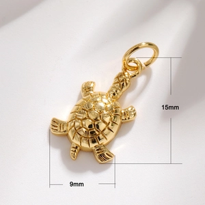 Macro shot of 15mm x 9mm golden turtle pendant with intricate shell details
