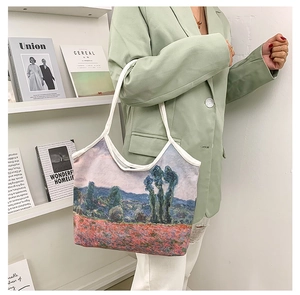 Artistic oil painting canvas tote bag styled with a soft green blazer and fashion magazines
