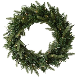 Lush green PE artificial Christmas wreath with warm yellow LED lights on white background