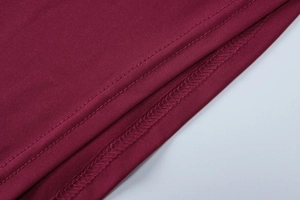 Close-up of wine red fabric showing high-quality double-stitch sewing and texture details