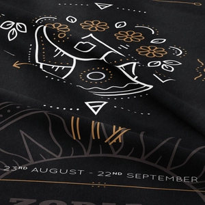 Macro shot of Virgo zodiac tapestry detail showing premium cotton fabric and dates