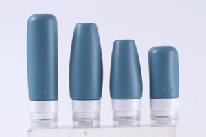Detail view of 100ml and 60ml silicone travel bottles with white flip caps on display