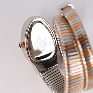 Snake-shaped quartz watch in two-tone silver and rose gold metal with engraved back case