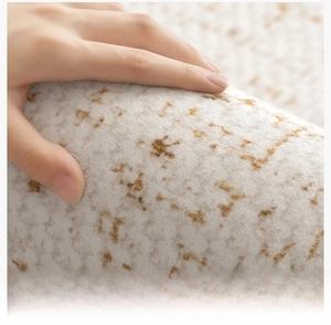Macro shot of cream-colored short-pile carpet showing fine yarn texture and softness