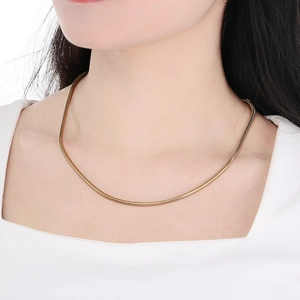 Close-up of elegant 3mm gold snake chain necklace worn by a model with a clean finish