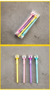 Close-up of four unicorn gel pens in pink yellow purple and blue with gift box