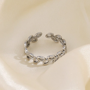 Adjustable silver leaf ring with olive branch design on elegant beige satin backdrop