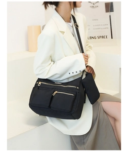 Fashionable black water-resistant nylon shoulder bag with adjustable strap and coin purse