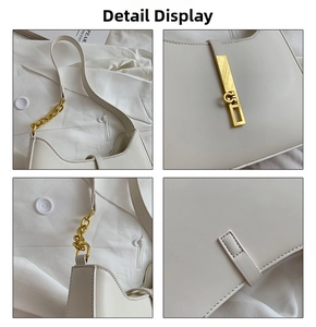 Close-up of white leather underarm bag with gold chain strap and metal buckle detail