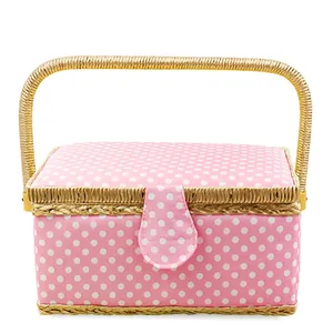 Pink polka dot sewing basket with woven handle and button closure in pastoral style