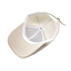 Interior view of beige quick-dry baseball cap with adjustable metal buckle and stitching
