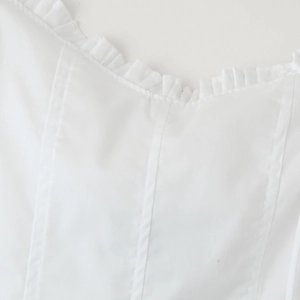 White square neck dress with ruffle trim details and decorative vertical seam lines